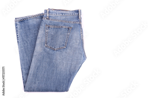 Stack of old blue jeans isolated on white