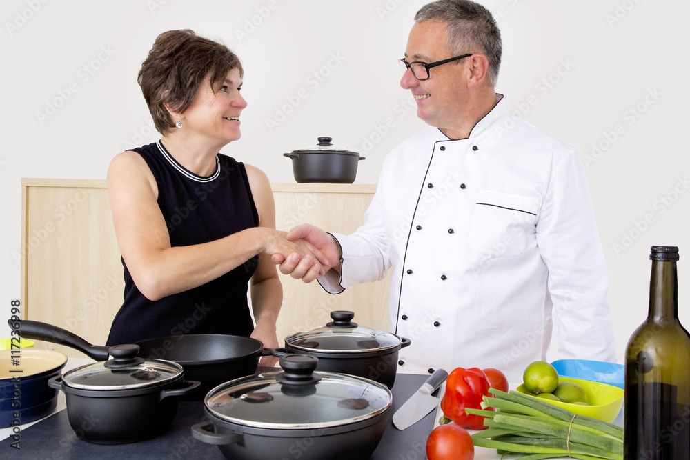 Elegant woman with Chef Cook in the kitchen Elegant woman with Chef Cook in the kitchen