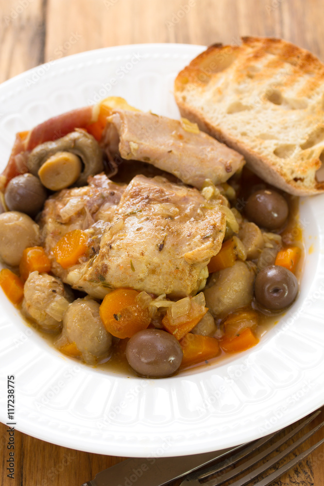 rabbit stew with mushrooms and carrot on white plate rabbit stew with mushrooms and carrot on white plate