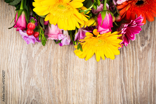 Various flowers on wooden background