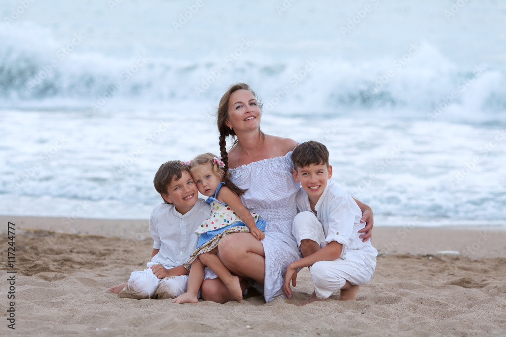 Portrait of cheerful, happy mother and sons on beach Portrait of cheerful, happy mother and sons on beach