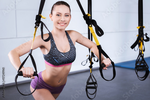 Young woman training with TRX
