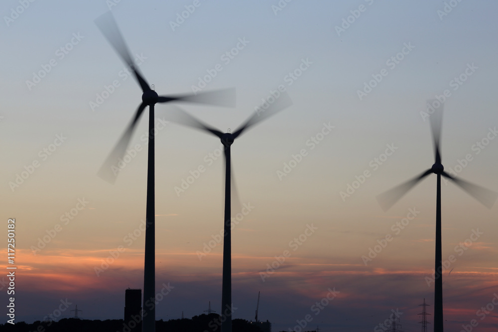 rotating windmill at sunset