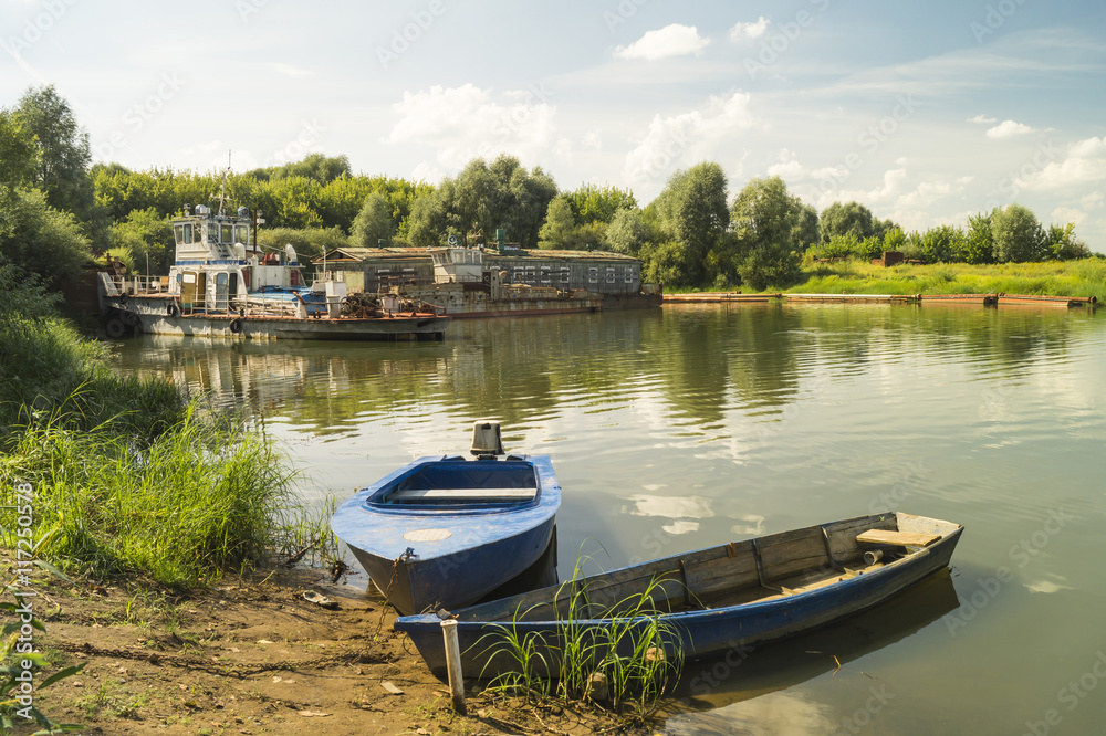 Fototapeta premium Boats on background old motorboat beside quay