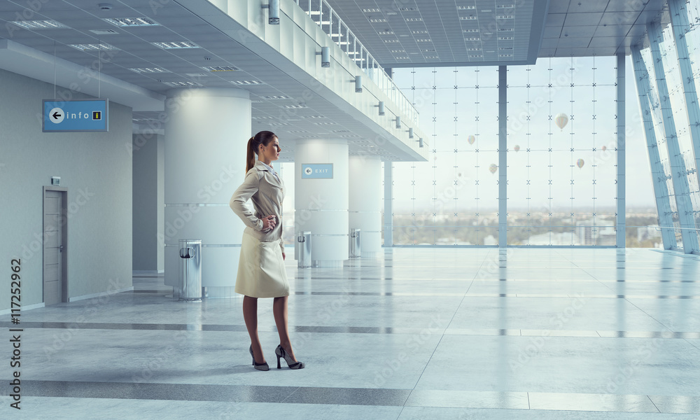 Businesswoman in modern office interior . Mixed media Businesswoman in modern office interior . Mixed media