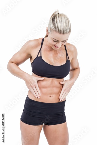 Female athlete touching her abs