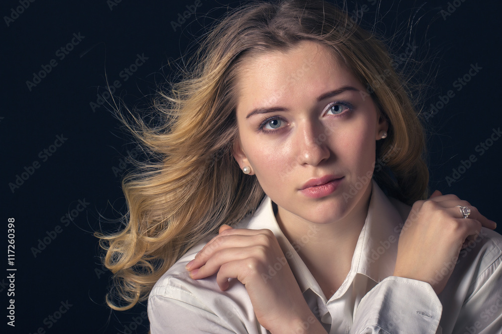Fototapeta premium Stylish young woman model standing on a dark background