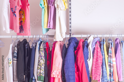 Choice of fashion clothes of different colors in walk-in clothin