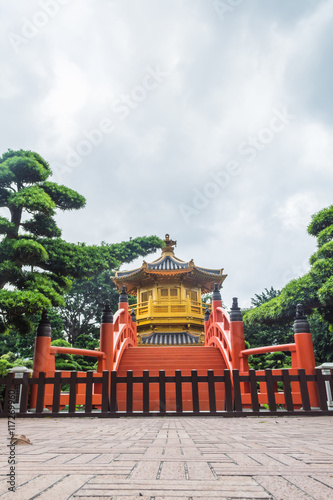 Golden pavilion with Chinese style architecture in Nan Lian garden, Hong Kong.