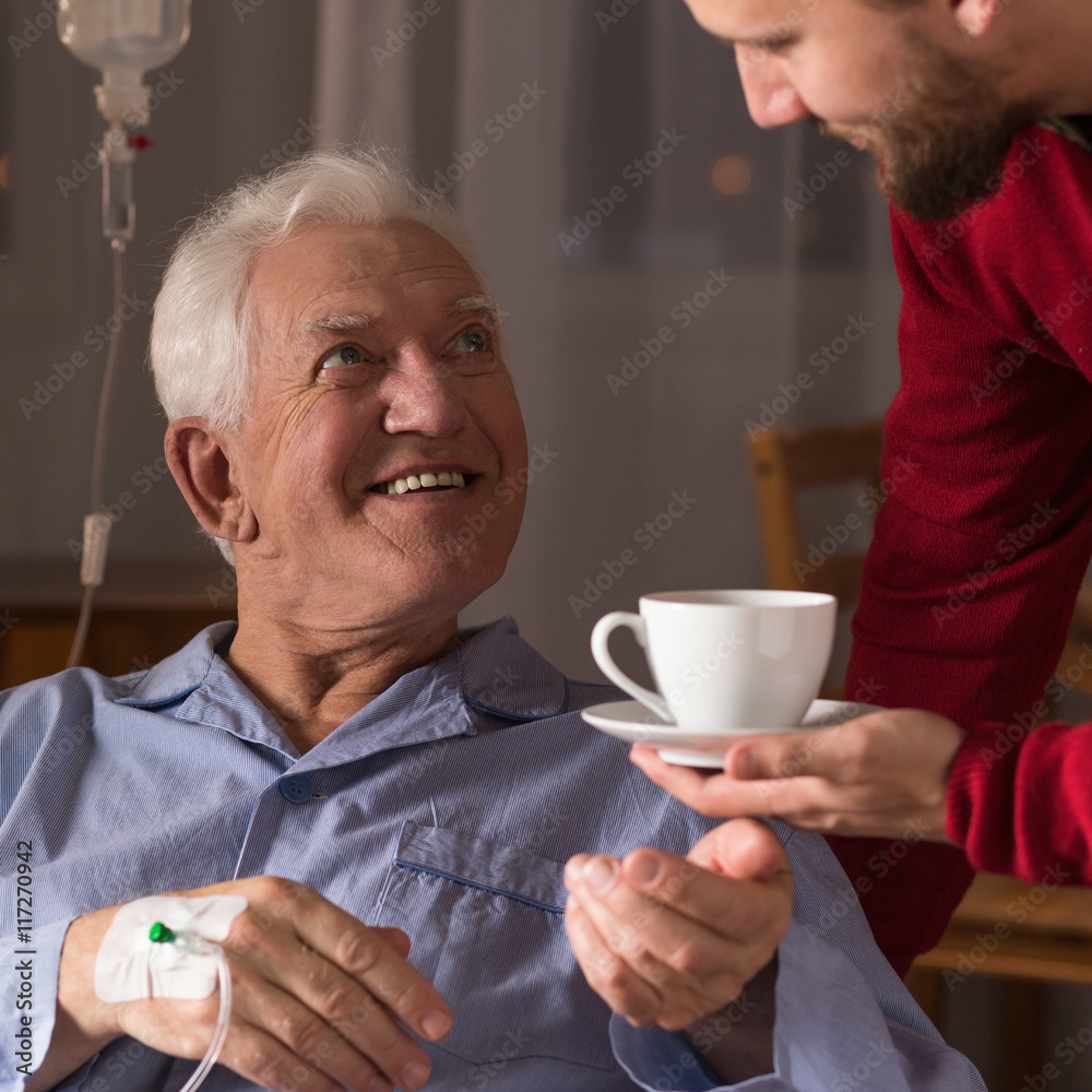 Carer assisting incurable ill man Carer assisting incurable ill man