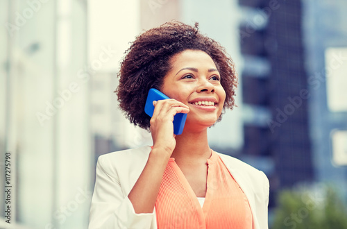 happy african businesswoman calling on smartphone