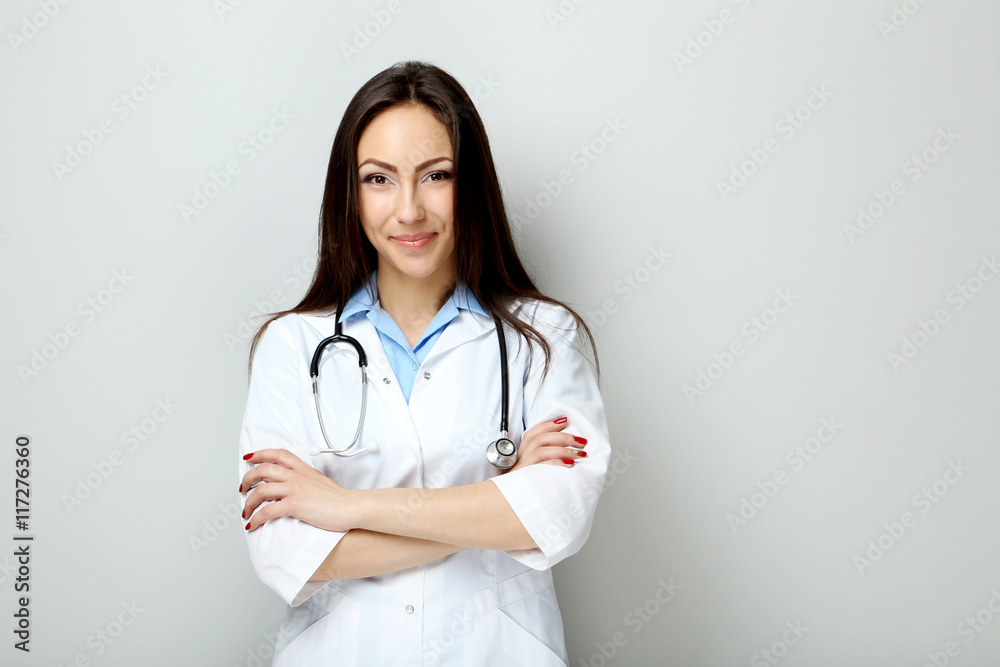 Portrait of young medical doctor on a grey background Portrait of young medical doctor on a grey background