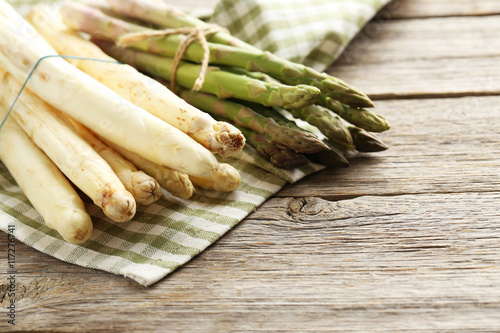 Fresh green and white asparagus on a grey wooden table