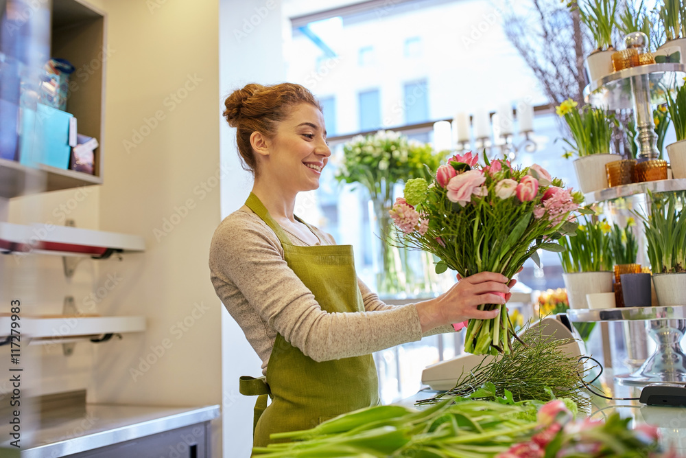 smiling florist woman making bunch at flower shop smiling florist woman making bunch at flower shop
