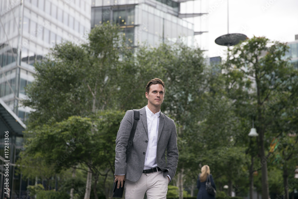 Businessman Walking To Work With City Office In Background Businessman Walking To Work With City Office In Background