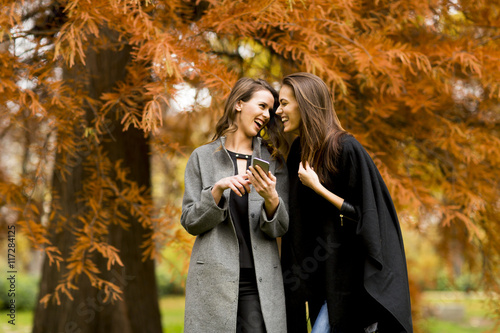 Young women with mobile pho...