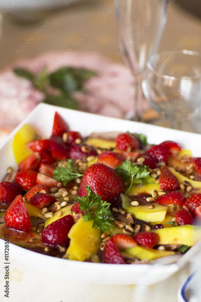 Fruit salad, dessert. Strawberries and mangoes in sweet and sour sesame sauce. Fruit salad, dessert. Strawberries and mangoes in sweet and sour sesame sauce.