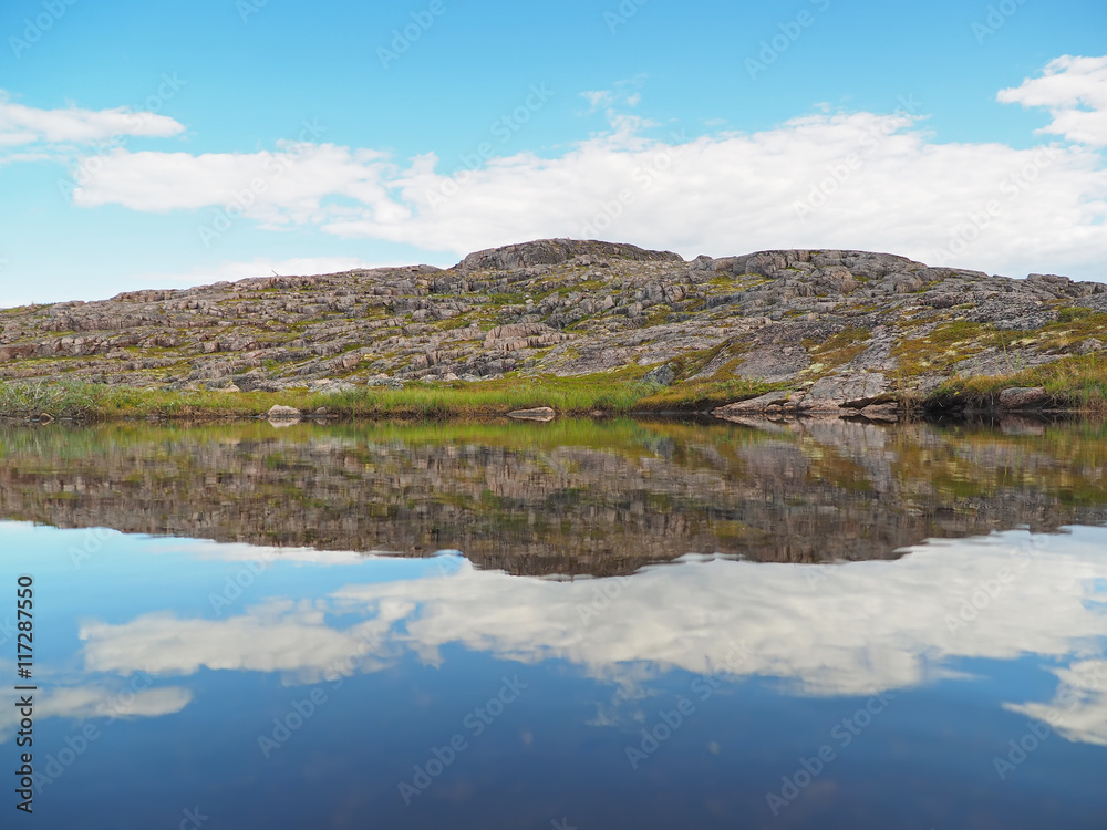 reflection in the lake. The coast of the Barents Sea