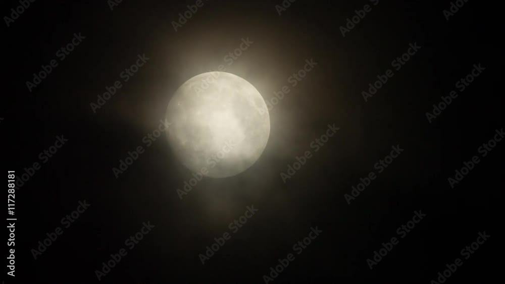 a full moon moving across the sky