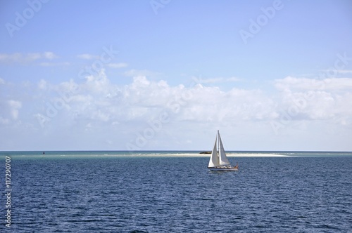  sailboat cruising at Moon Point Sandbank located in the Great Sandy Strait off the shores of Fraser Island, Queensland Australia