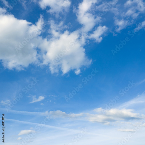 Beautiful cloudscape over horizon. White clouds and blue sky.