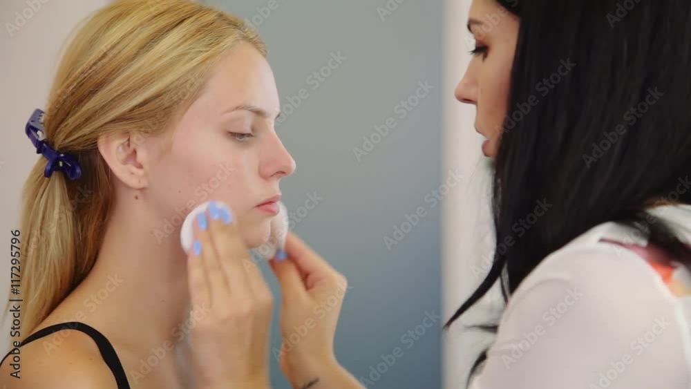 Make-up artist cleaning skin on model's face. Concept of skin care Make-up artist cleaning skin on model's face. Concept of skin care