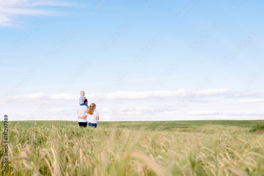 parents with the child walk across the field parents with the child walk across the field