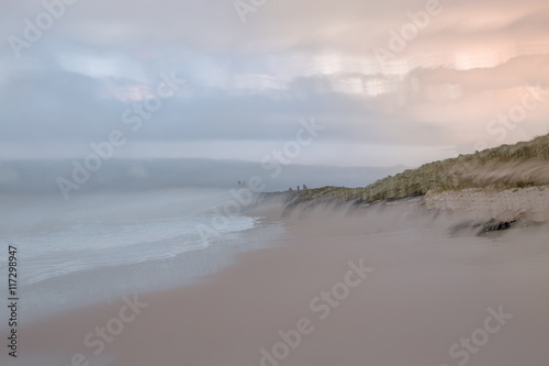 View of sandy beach against cloudy sky