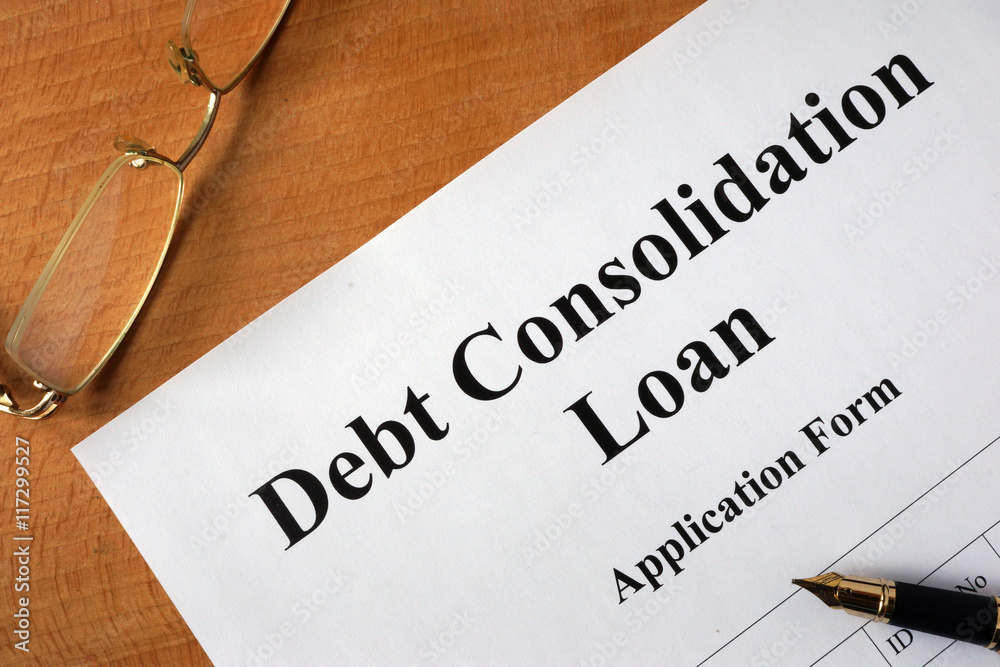 Debt consolidation loan form on a wooden table. Debt consolidation loan form on a wooden table.