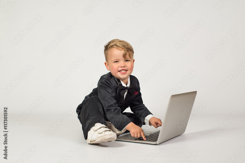 a child in the role of office manager with laptop and phone a child in the role of office manager with laptop and phone