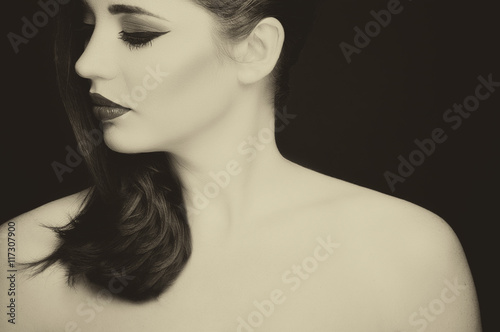 Gorgeous young woman with long eyelashes. Perfect makeup. Vintage style photo