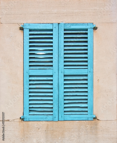 Turquoise window with shutters