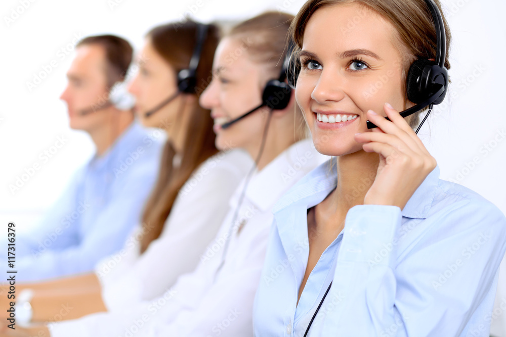 Young beautiful business woman in headset. Call center operator. Young beautiful business woman in headset. Call center operator.