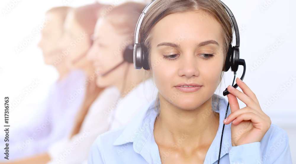 Young beautiful business woman in headset. Call center operator. Young beautiful business woman in headset. Call center operator.