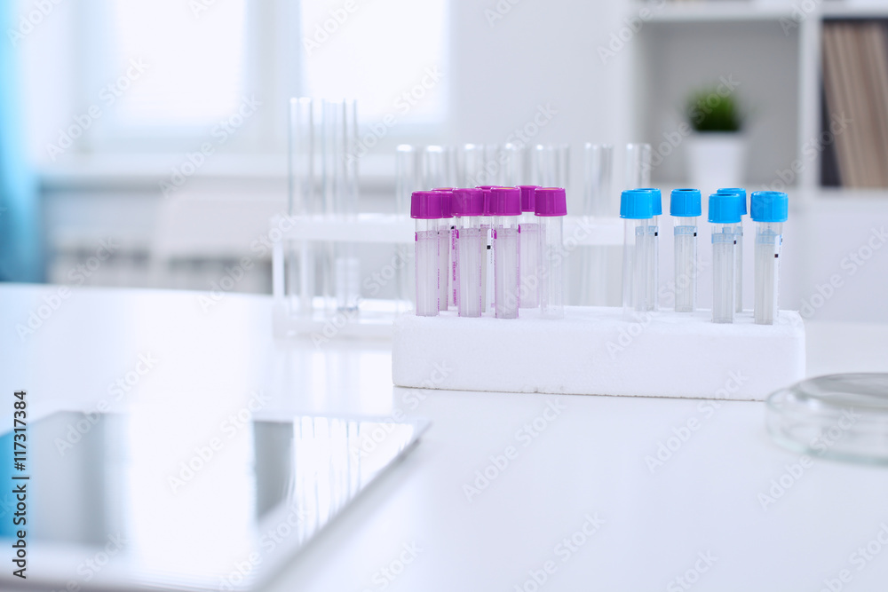 Research laboratory working space. Test tubes and tablet PC are lying at the table. Medical equipment. Blood test Research laboratory working space. Test tubes and tablet PC are lying at the table. Medical equipment. Blood test