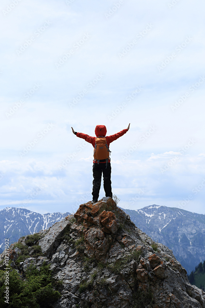 successful young woman backpacker open arms on mountain peak successful young woman backpacker open arms on mountain peak