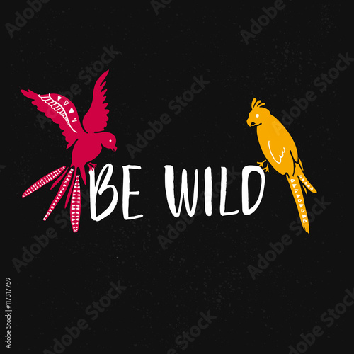 Be wild text with hand drawn parrots. Pink and yellow bird sitting on the text at black background.