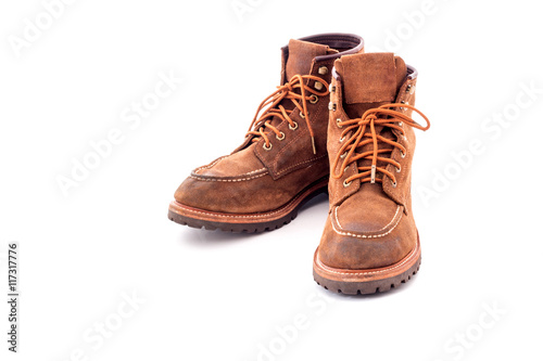 Pair of old yellow working boots Isolated on white background