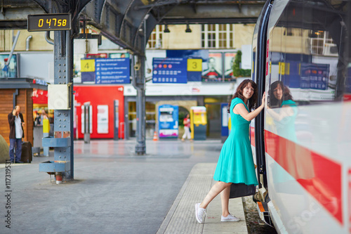 Young woman on the platform of a train station