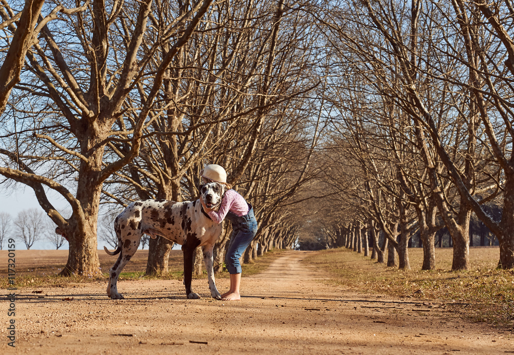 Young girl child playing walking her dog great dane Young girl child playing walking her dog great dane