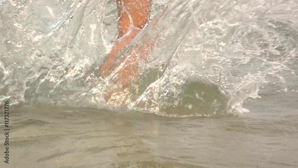 Slow motion of young women kick sea wave
Slow motion of young women kick sea wave