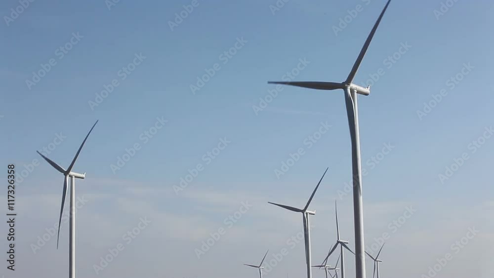 Wind turbines for green energy concept, taken on a cloudy day with dust environment Wind turbines for green energy concept, taken on a cloudy day with dust environment