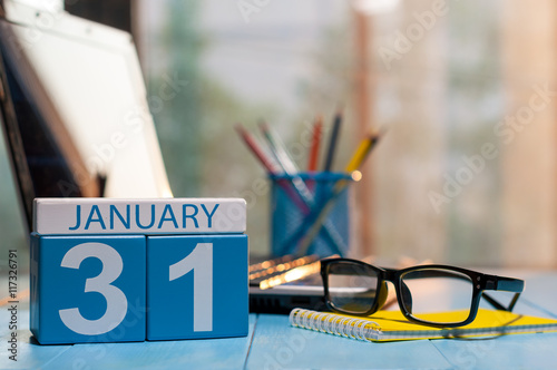 January 31st. Day 31 of month, calendar on workplace background. Winter at work concept. Empty space for text photo