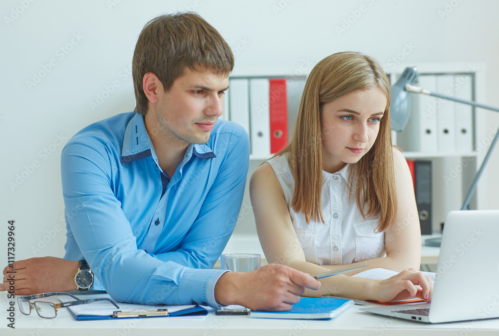 Business team working on their business project together at office. Business team working on their business project together at office.