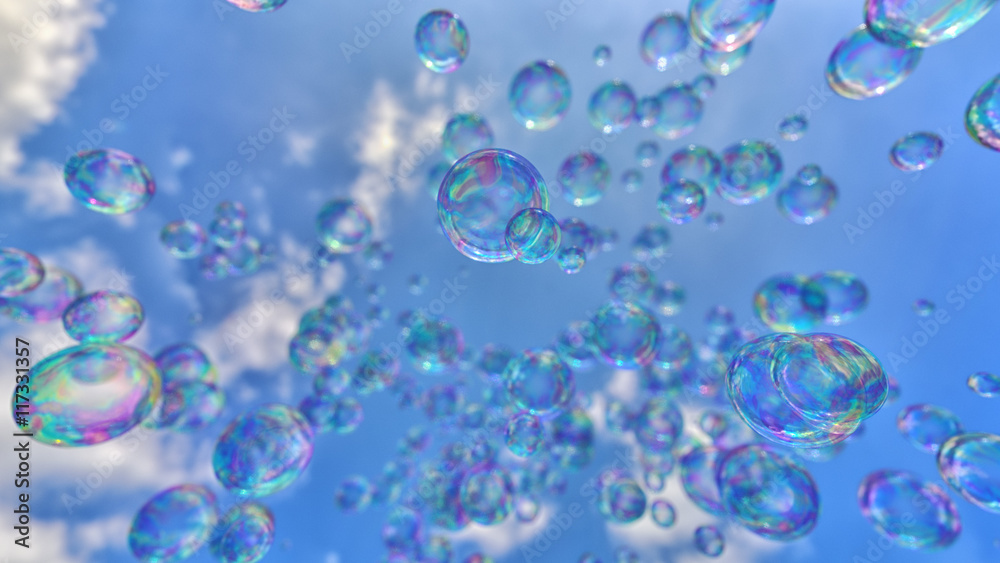 Vibrantly colored soap bubbles against a clean blue sky.