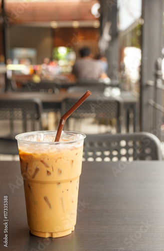 iced coffee in plastic cup at cafe