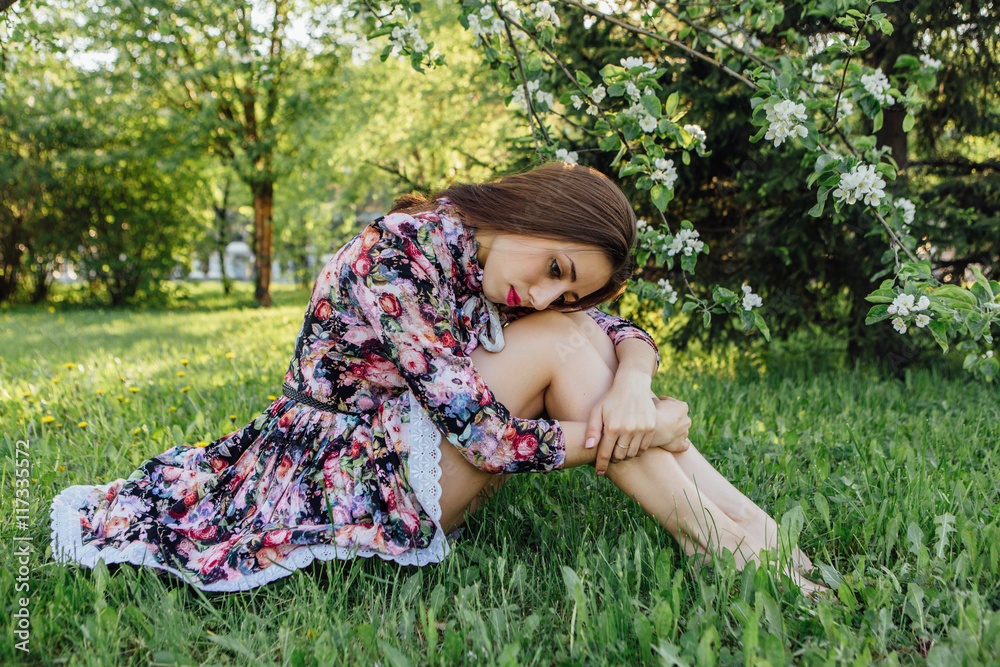 Beautiful young woman standing near the apple tree. Beautiful young woman standing near the apple tree.