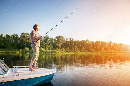 Mature man on a motor boat. Fishing © tarasov_vl