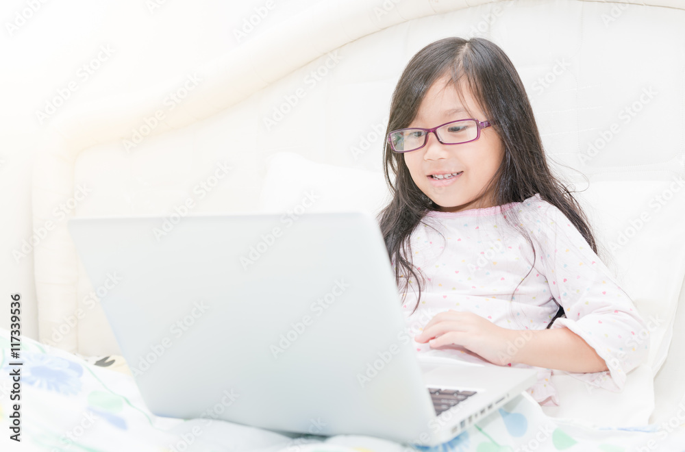 Cute girl working on laptop computer concept for education