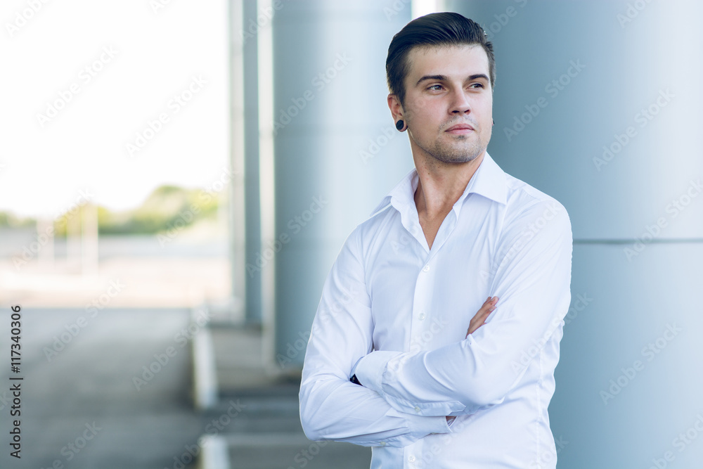 handsome buisnessman standing near business centre handsome buisnessman standing near business centre